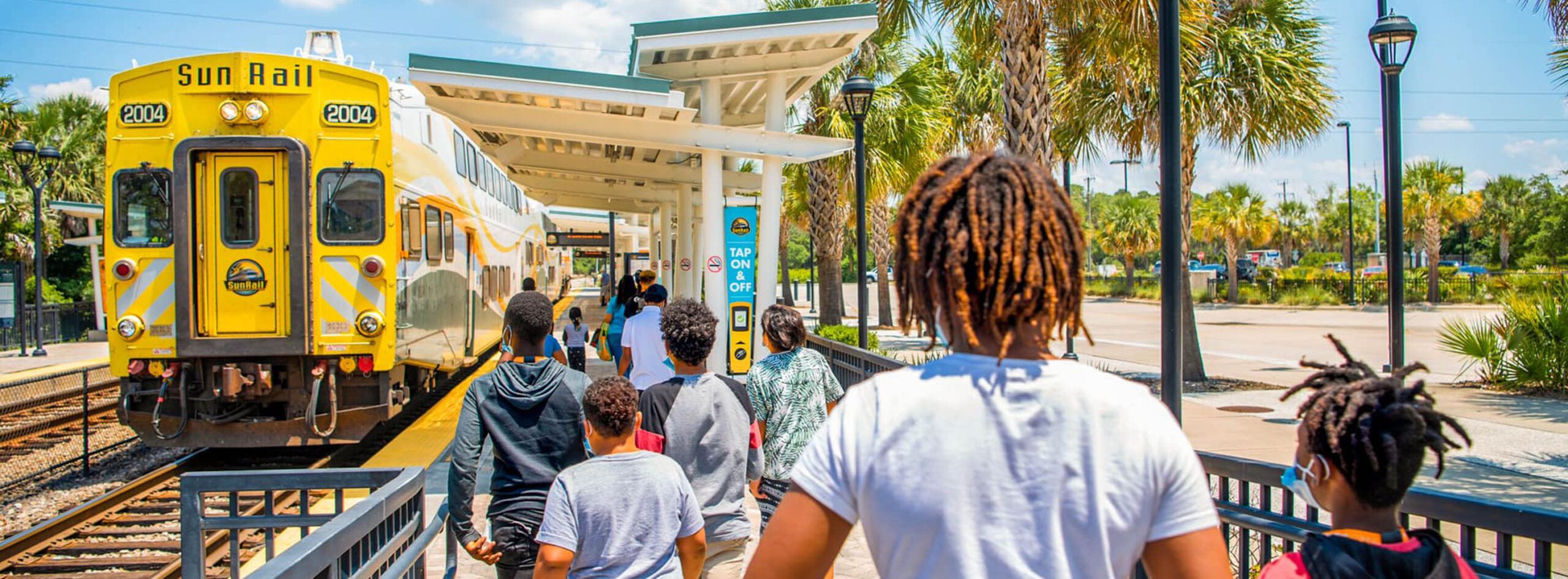 Masthead image - Group of kids approaching SunRail Train for a group ride.