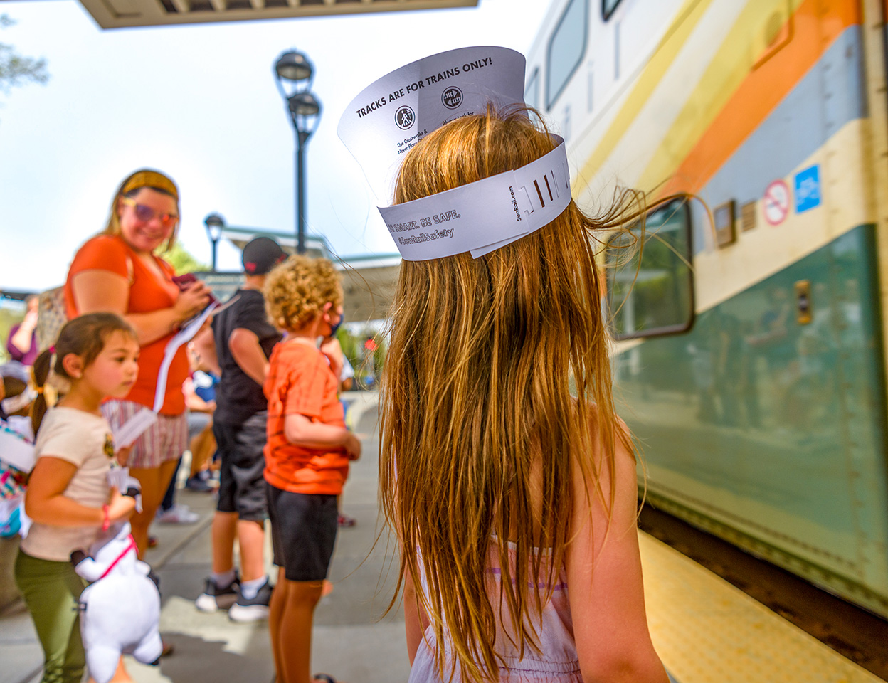 Young girl with group waiting on platform waiting to board SunRail Train.