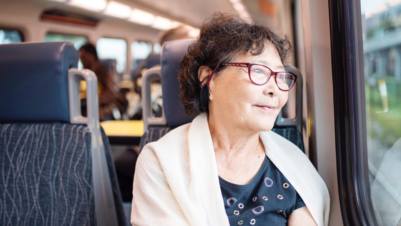 Landing Page image - Senior lady riding SunRail looking out the window