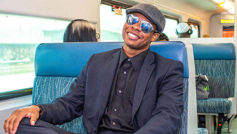 Landing Page image - Professional man with sunglasses riding SunRail to work