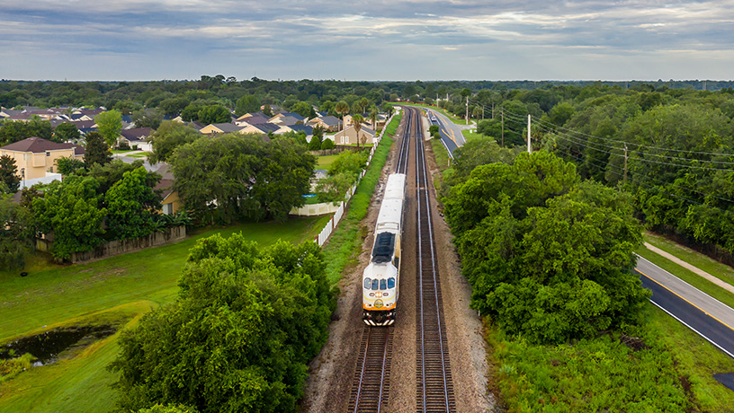 Landing Page image - Aerial image of SunRail train traveling along tracks