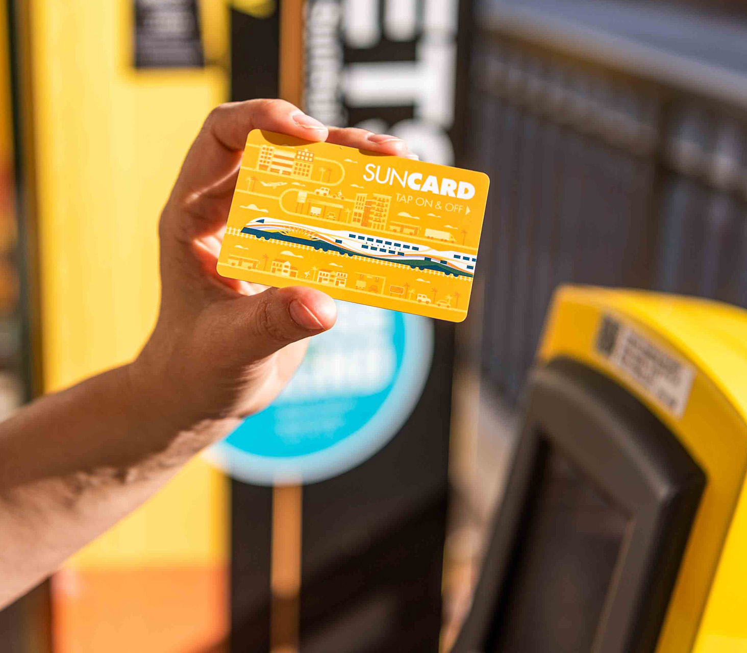 Person holding SunCard by Ticket Validation Unit (TVU).