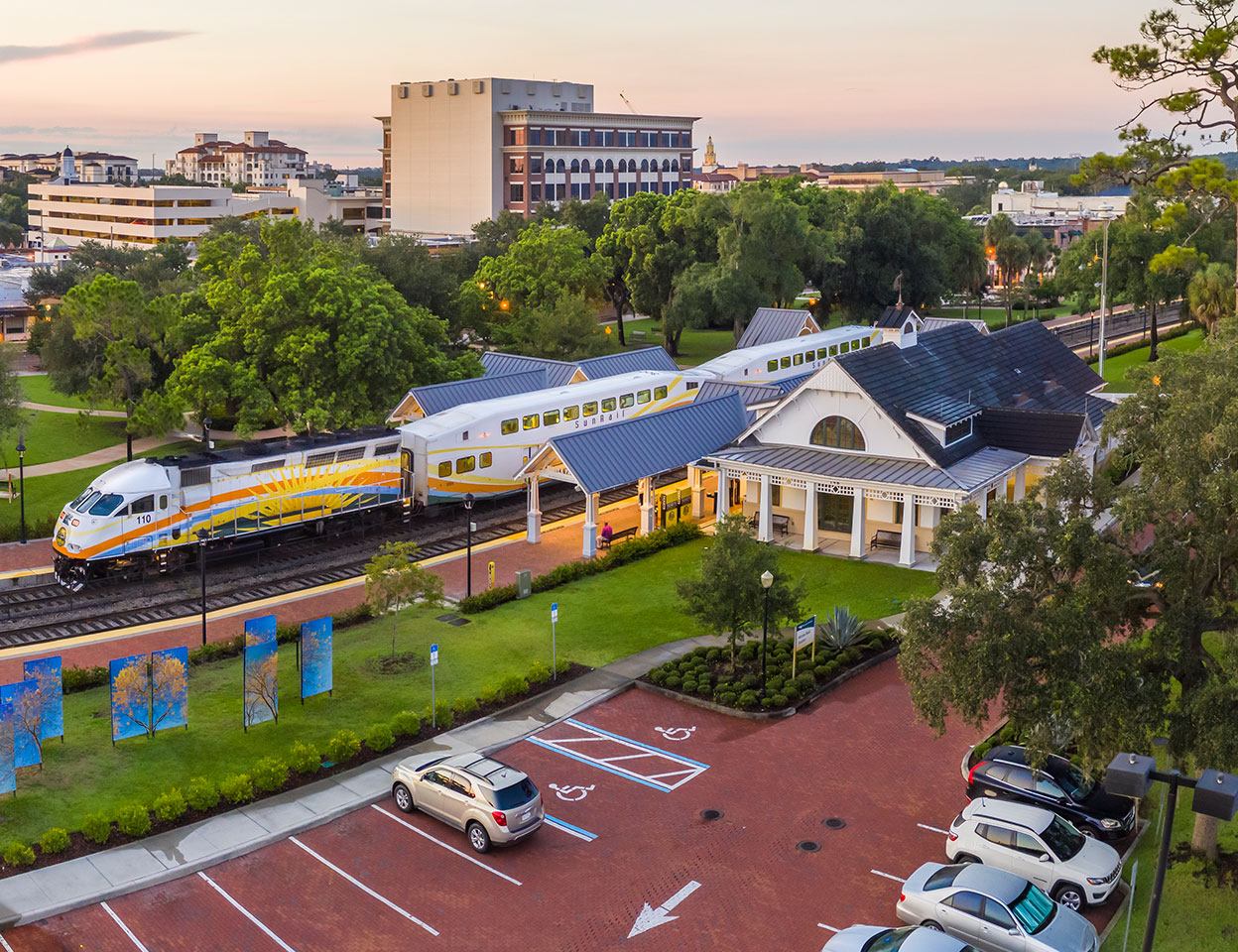 SunRail Train at Winter Park Station with parking lot ADA parking spots.