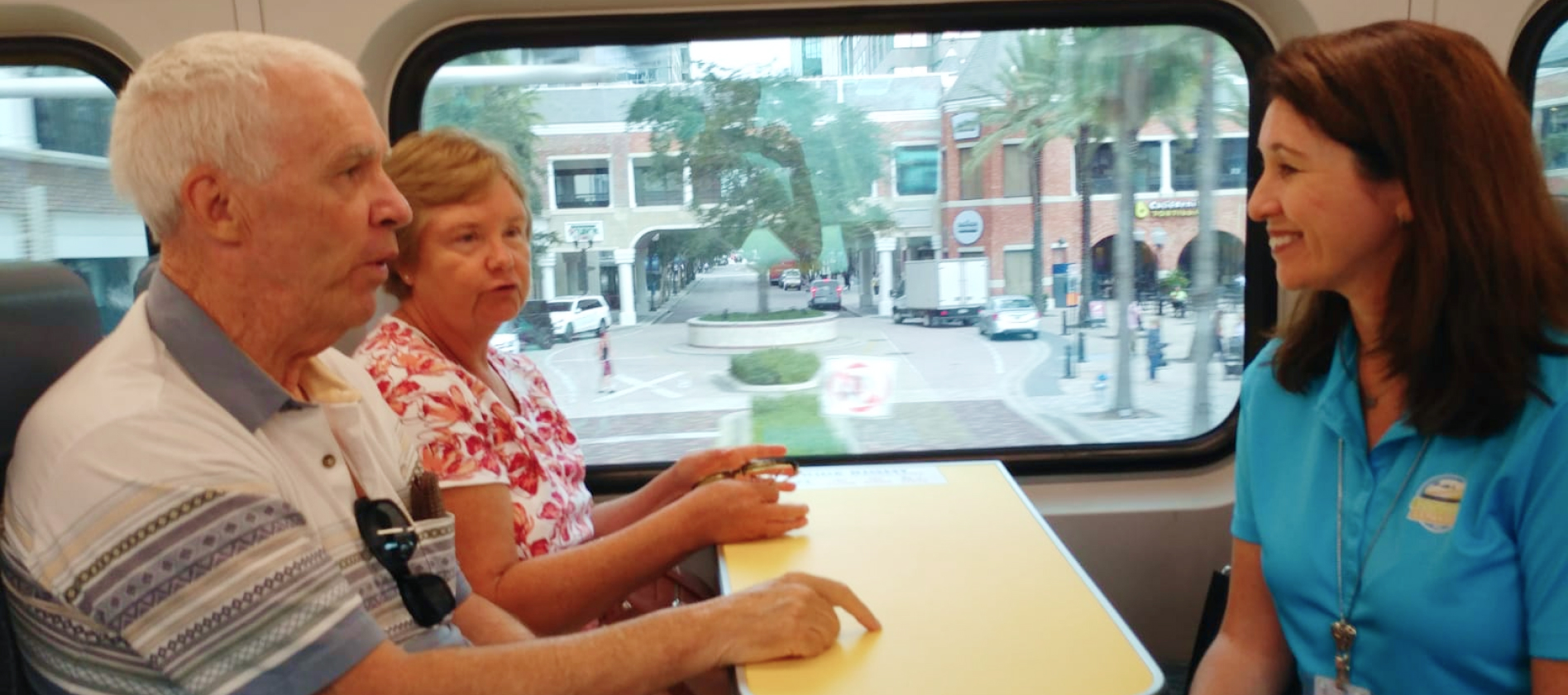 Suzanne & Jerry ride with SunRail CEO, Nicola Liquori as they pass Church Street Station.