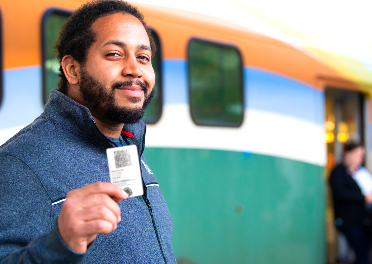 Man holding a SunRail ticket, getting ready to board a SunRail train.