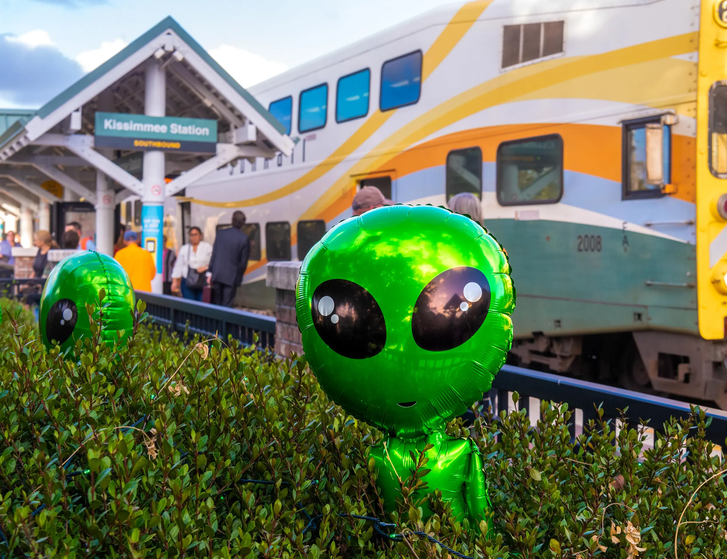 Boo! On Broadway 2023 balloons sit in the foreground at the SunRail Kissimmee / Amtrak station.