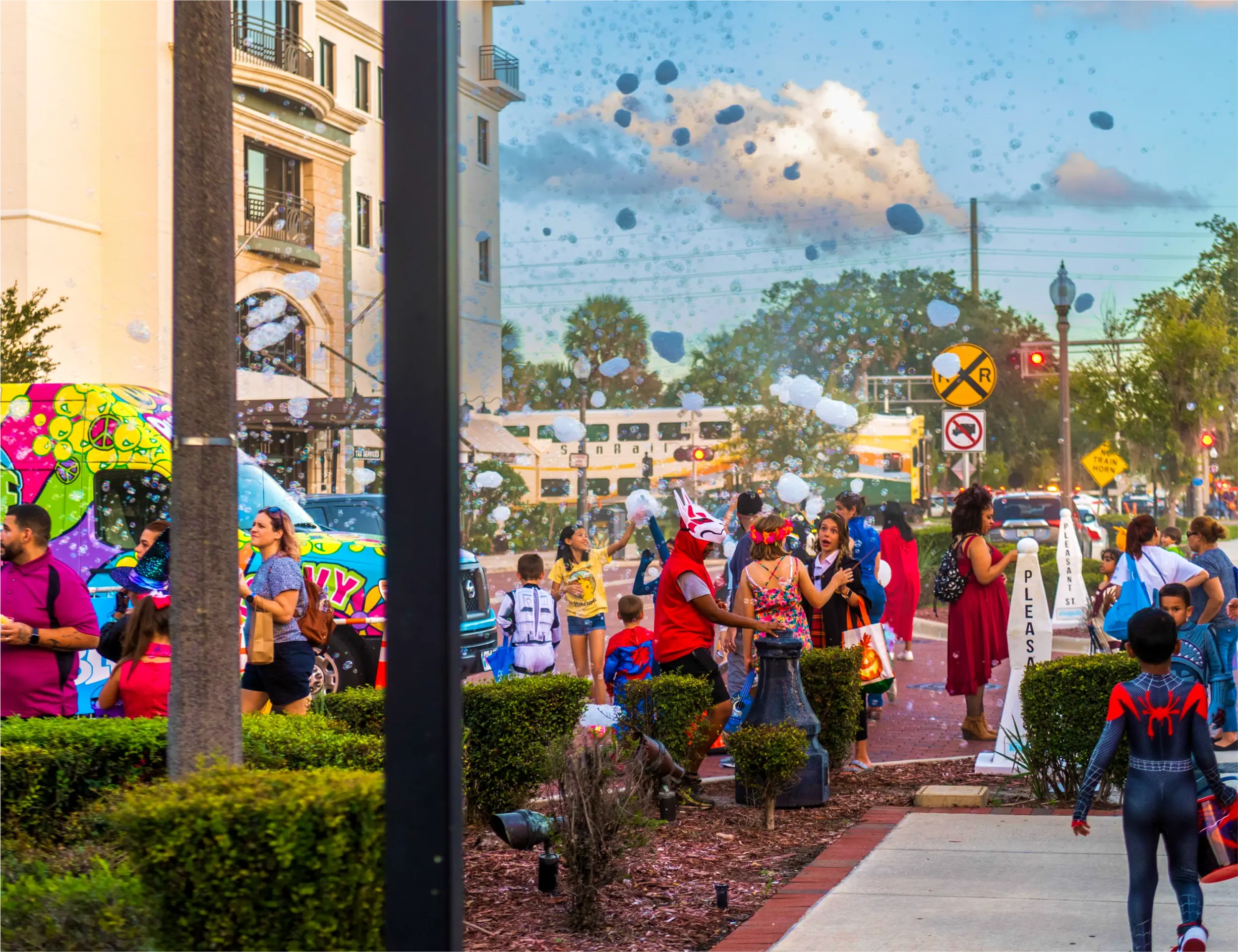 Boo! On Broadway 2023 patrons enjoy the festivities as a SunRail Train sits in the background.