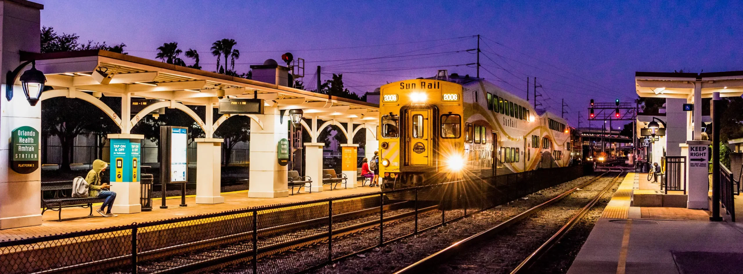 Train departing the Orlando Health / Amtrak SunRail station in the evening.