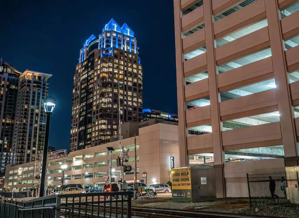 Orlando skyscraper lit at night as seen from the Church Street Station platform.